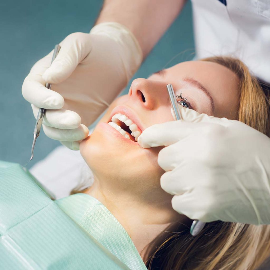 Patient receiving a dental exam and treatment at Elite Dental & Wellness in Mesa, AZ