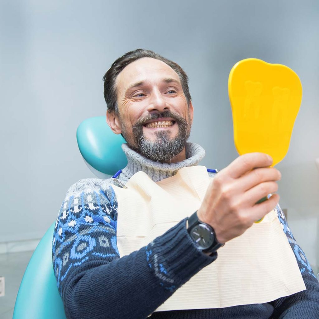 Man smiling after receiving dental care at Elite Dental & Wellness in Mesa, AZ